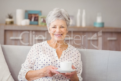 Portrait of senior woman holding coffee cup