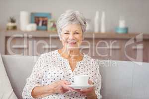 Portrait of senior woman holding coffee cup