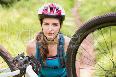 Woman fixing her bike