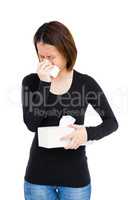 Sick woman blowing her nose with tissue paper