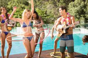 Happy friends enjoying at the swimming pool