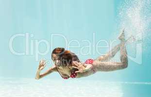 Portrait of happy young woman swimming