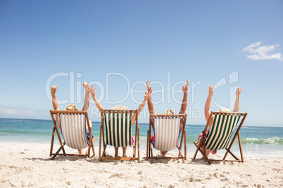 Senior friends sitting in beach chair