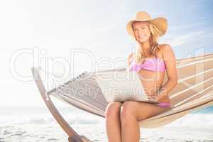 Woman using her laptop in hammock