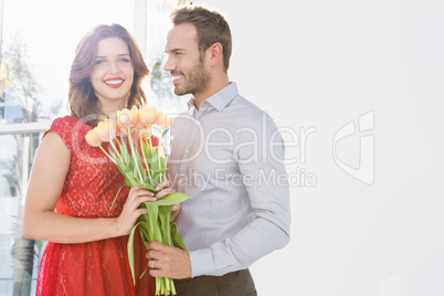 Man offering flower bouquet to woman