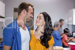 Young man and young woman standing in kitchen