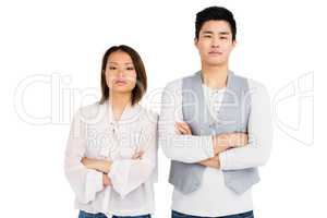 Upset couple standing with arms crossed