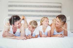 Happy family relaxing on bed