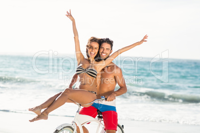 Couple going on a bike ride on the beach