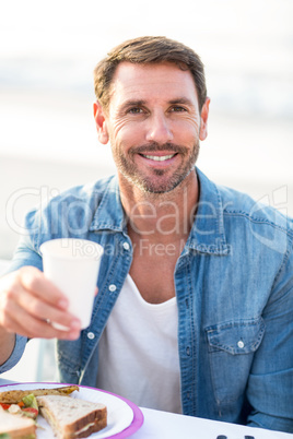 Smiling man having a picnic