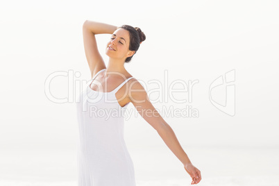Beautiful woman stretching on the beach