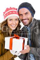 Happy young couple holding gift
