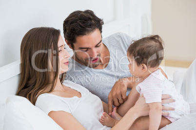 Couple playing with baby girl at home