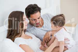 Couple playing with baby girl at home