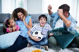 Family watching match together on television