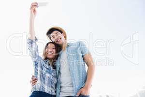 Happy young couple taking a selfie