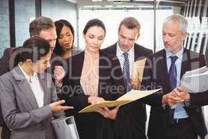Lawyer looking at documents and interacting with businesspeople