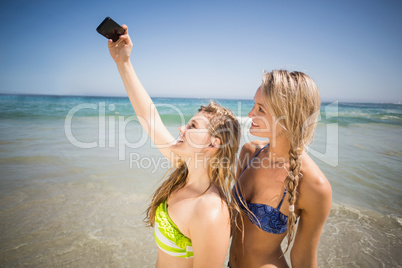 Two friends in bikini taking a selfie