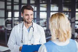 Smiling doctors discussing