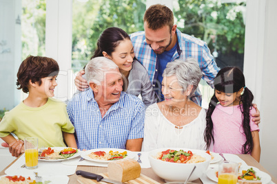 Multi generation family discussing at dining table