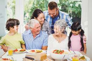 Multi generation family discussing at dining table