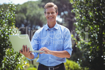 Handsome businessman using laptop