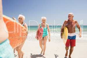 Senior friends holding surfboard