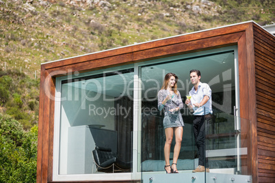 Young couple standing in balcony at resort