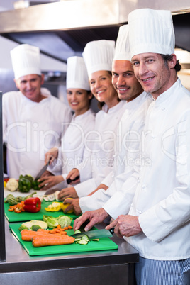 Team of chefs chopping vegetables