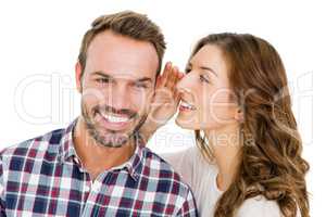 Woman whispering into mans ears