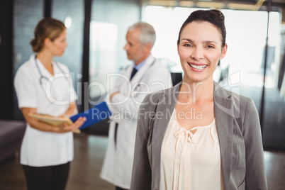 Portrait of smiling businesswoman in hospital