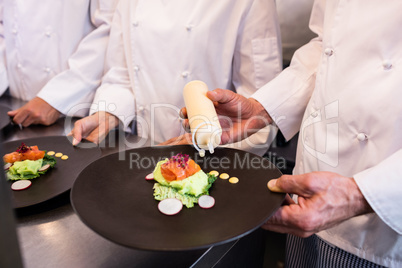 Chef decorating a food plate