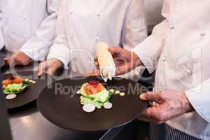Chef decorating a food plate