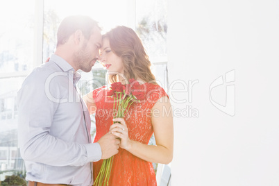 Man offering flower bouquet to woman