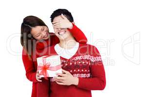 Woman giving a surprise gift to her man