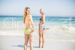 Two happy women in bikini enjoying on the beach