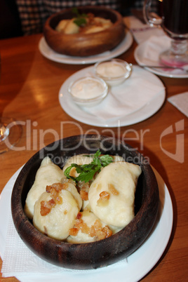 Varenyky with fried slices of bacon in restaurant