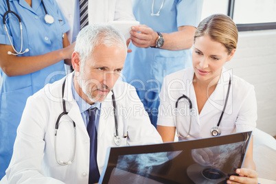 Two doctors examining an x-ray report