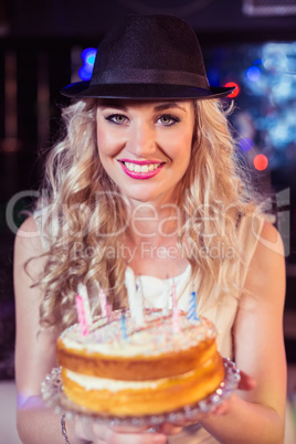 Smiling woman holding a cake