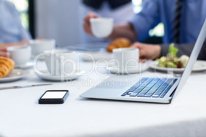 Laptop and mobile phone on the restaurant table