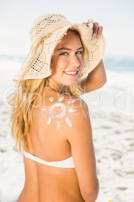 Smiling woman with sunscreen on her skin