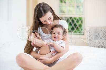 Mother playing with baby at home