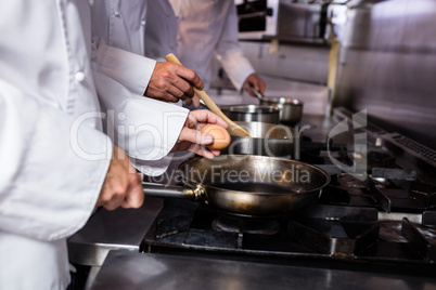 Close-up of chef preparing egg