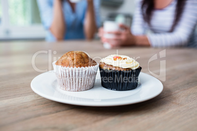 Muffin and cupcake served in plate on table