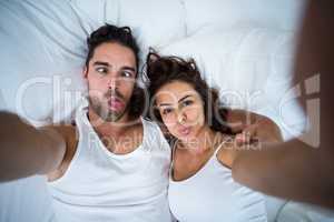 Couple making faces while taking self portrait