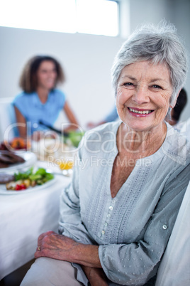 Portrait of senior woman sitting at dinning table