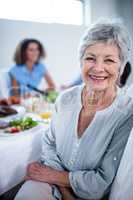 Portrait of senior woman sitting at dinning table