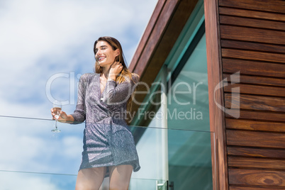 Gorgeous woman standing by glass railing