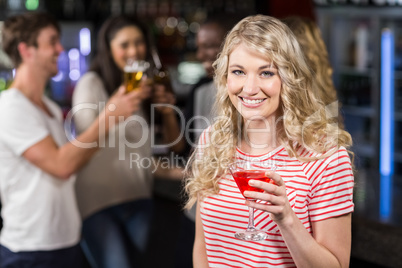 Blonde woman having cocktail with her friends