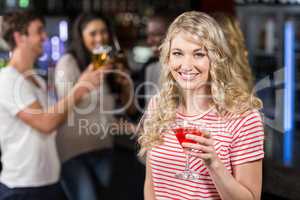 Blonde woman having cocktail with her friends